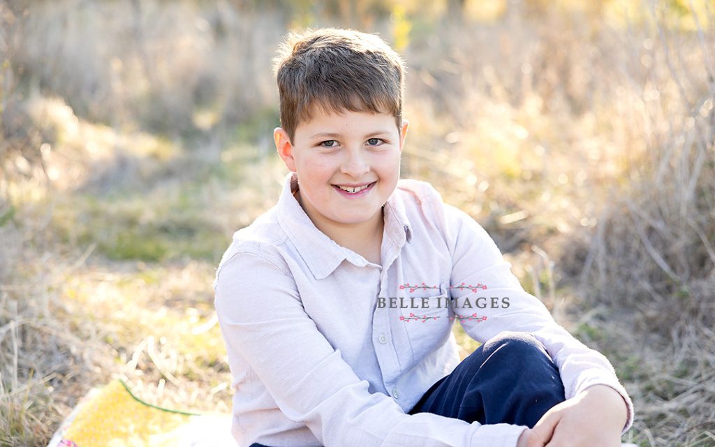 boy sitting on ground at toowoomba family photo session