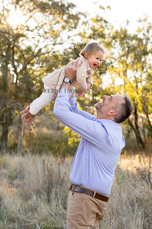 Dad lifting baby in air at toowoomba family photo session